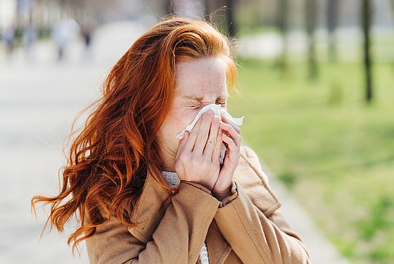 Allergikerin putzt sich die Nase